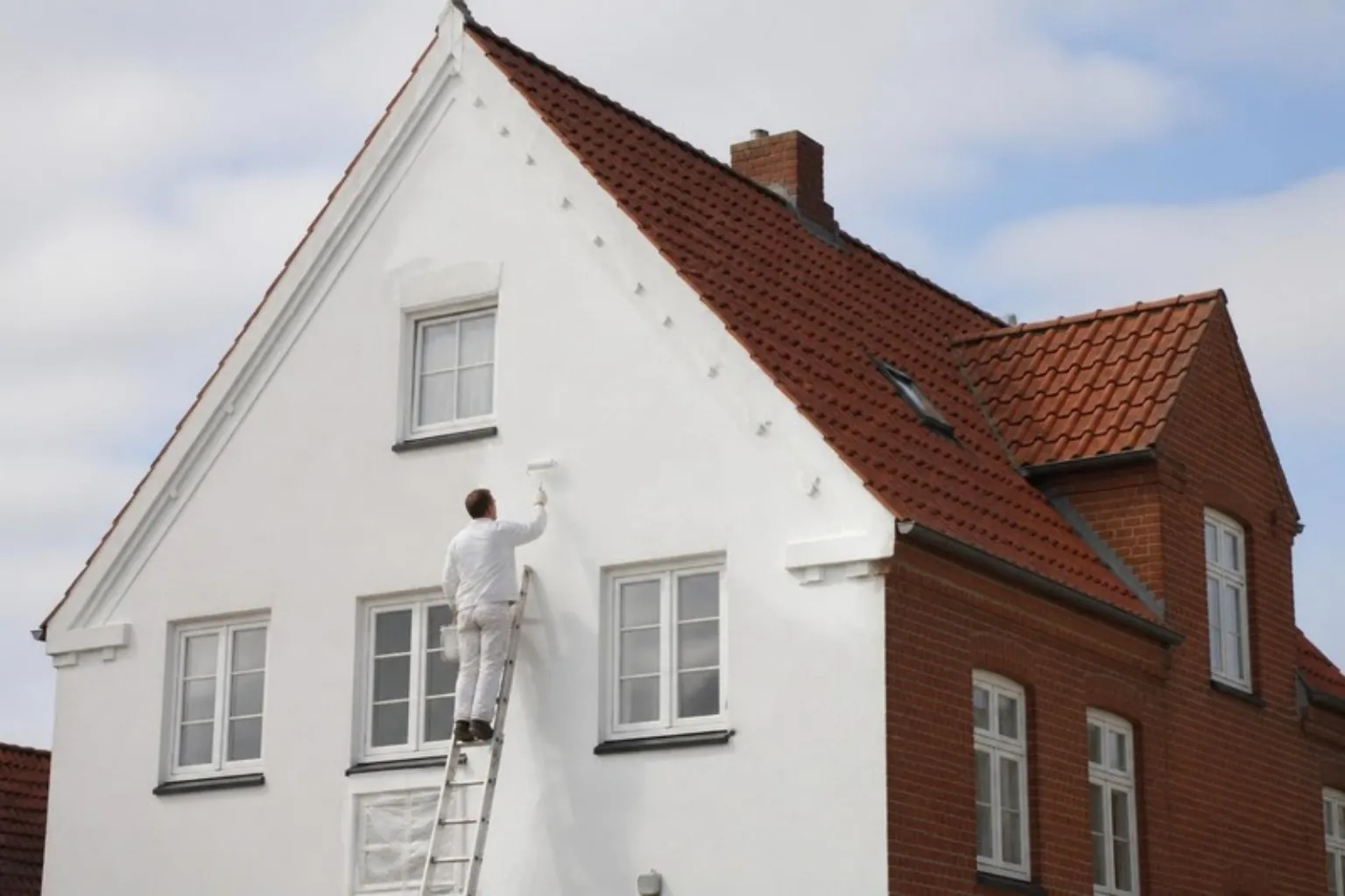 Maler på stige maler hvid facade